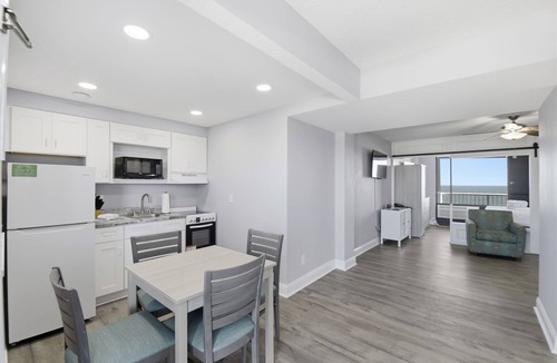 Ormond Beach Apartment | Beachfront Studio | Kitchen + Pool & Picnic Area